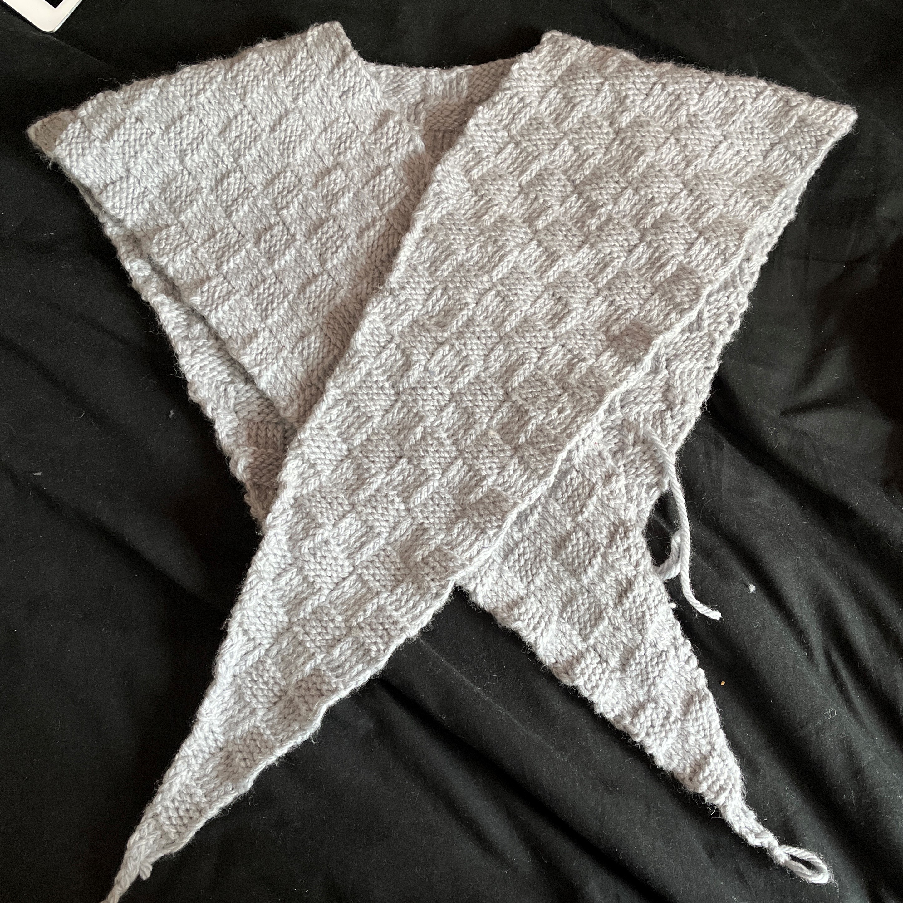 sontag shawl laid flat on a bed