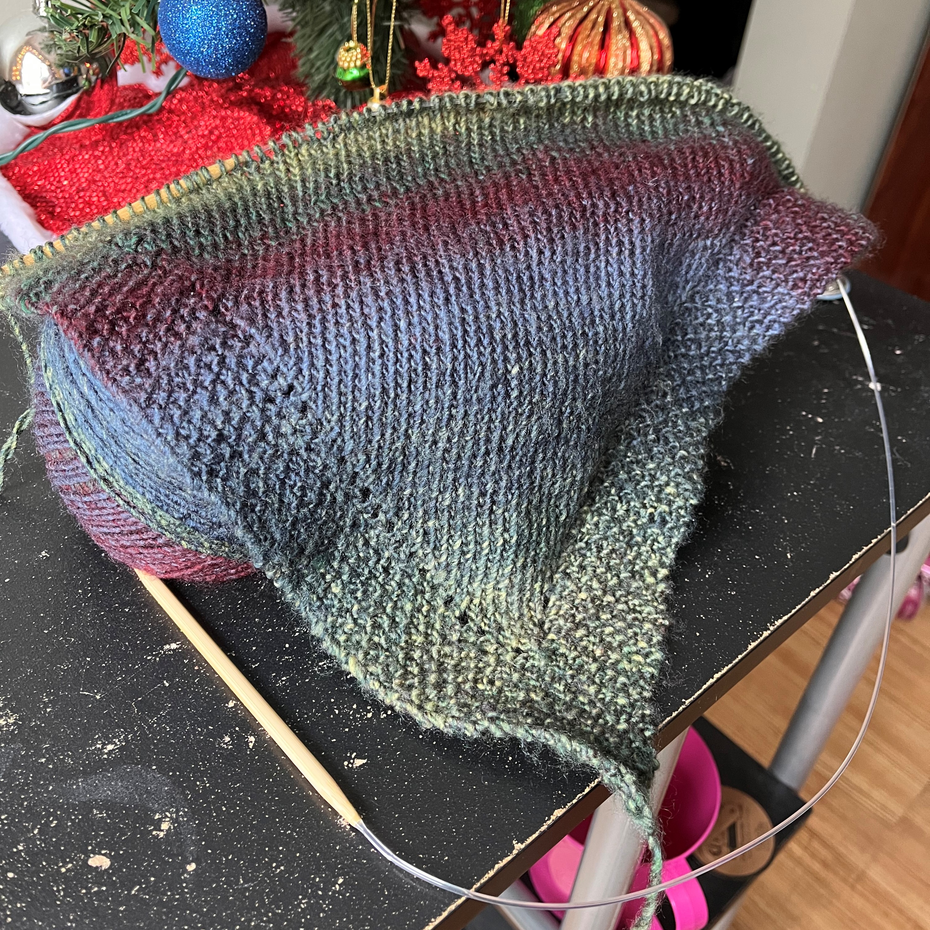 in-progress photo of a multicolored knitted shawl
